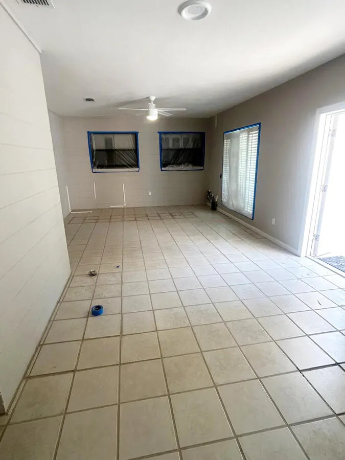 Great room before painting and flooring, prepped with tape